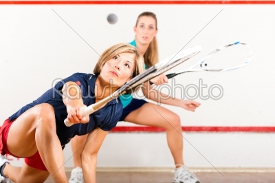 Squash sport - women playing on gym court