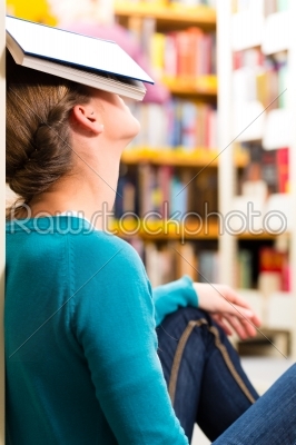 student in library tired and overworked