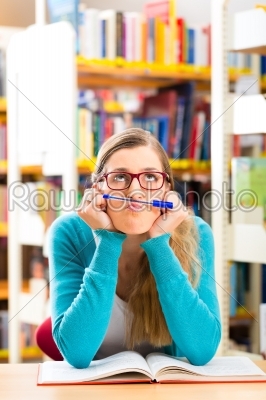 Student with books learning in library