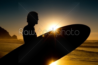 Surfer and board in evening sun