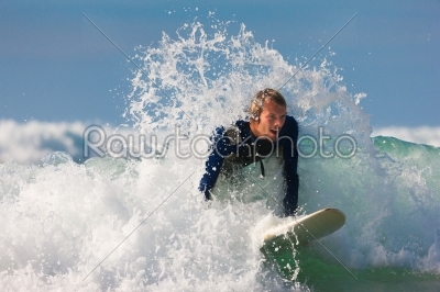 Surfer and board in sea with waves