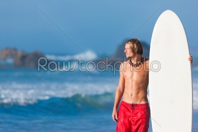 Surfer with board on beach
