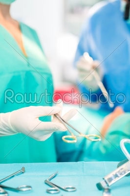 Surgeons operating patient in operating room 