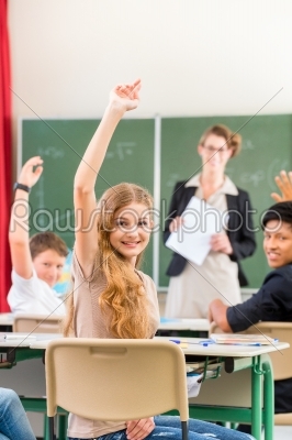 Teacher teaching a class of  pupils in school