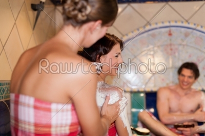 Three friends in sauna of a thermal bath