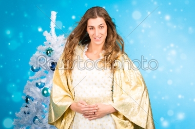 Traditional Christmas Angel in front of tree