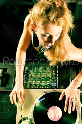 Two DJs at the turntable in club