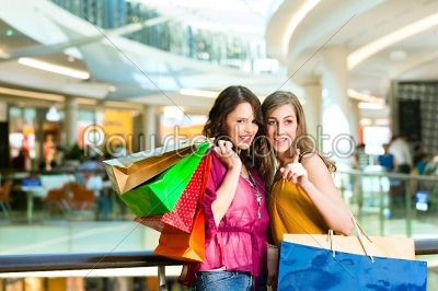 Two female friends shopping in a mall
