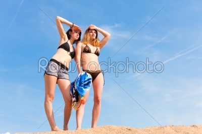 two young women with blue sky in summer