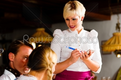 Waitress in Bavarian restaurant taking orders