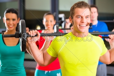 weight training in the gym with dumbbells