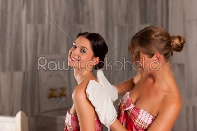 Wellness - two female friends getting a massage and cleansing