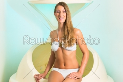Wellness - young woman floating in Spa in bathtub