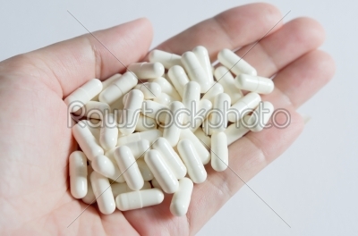 white pills on hand
