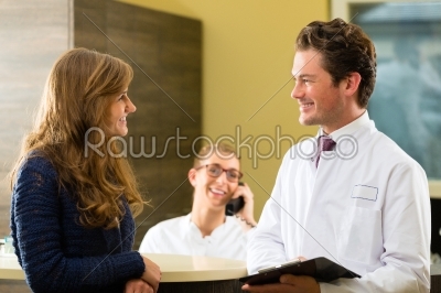 Woman and doctor at reception of clinic
