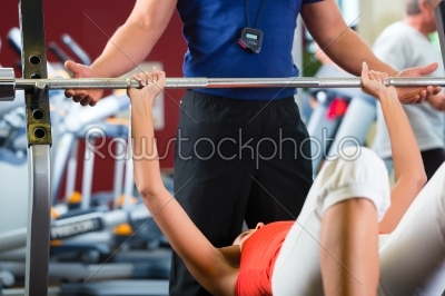 woman and Personal Trainer in gym