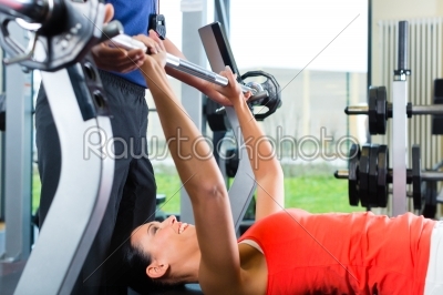 woman and Personal Trainer in gym