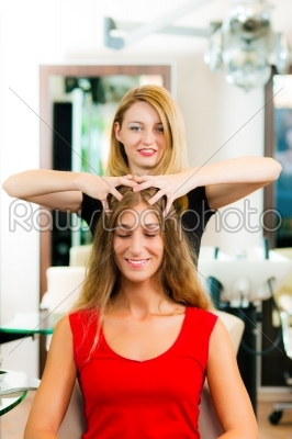 Woman at the hairdresser getting a head massage