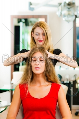 Woman at the hairdresser getting a head massage