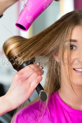 Woman at the hairdresser having hair dried