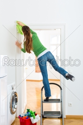 Woman at the spring cleaning working dangerously