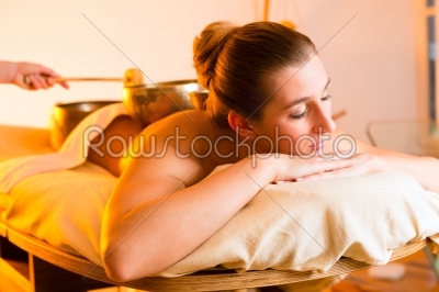 Woman at Wellness massage with singing bowls