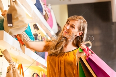 Woman buying a bag in mall
