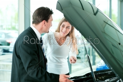 Woman buying car from salesperson