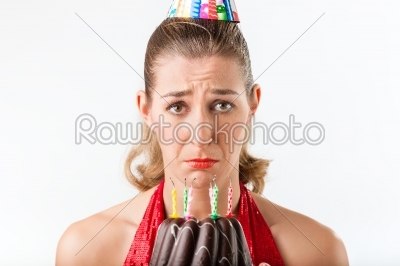Woman celebrating birthday with cake candles wiped