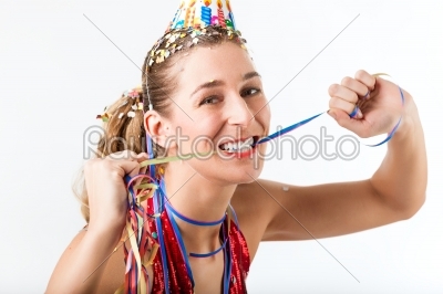 Woman celebrating birthday with streamer and party hat