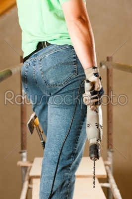 Woman Construction worker with hand drill