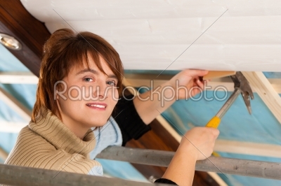 Woman doing dry walling, working