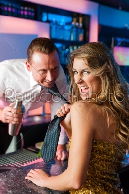 Woman dragging barkeeper in club or bar