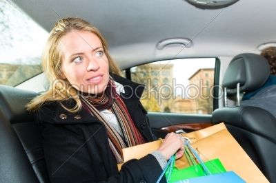 Woman driving in taxi, She was shopping