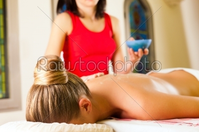 Woman enjoying massage in wellness spa