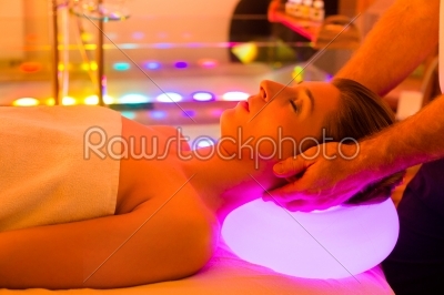 Woman enjoying therapy in spa with color therapy