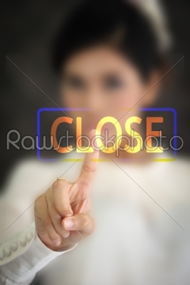 woman hand pressing close button on a touch screen 