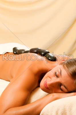 Woman having a hot stone therapy session