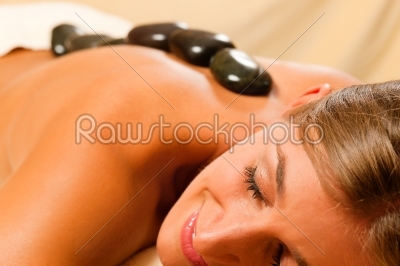 Woman having a hot stone therapy session