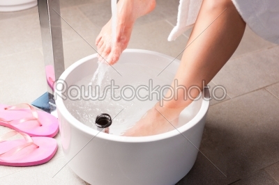 Woman having hydrotherapy water footbath