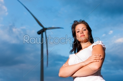 Woman in front of windmill and sky