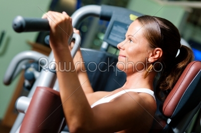 Woman in gym on machine