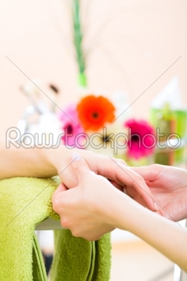 Woman in nail salon receiving hand massage