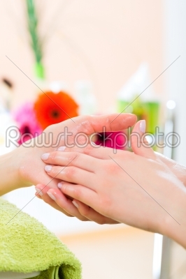 Woman in nail salon receiving hand massage
