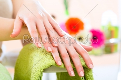 Woman in nail salon receiving nail care