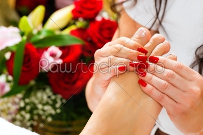Woman in nail studio receiving foot massage