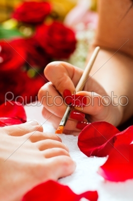 Woman in nail studio receiving pedicure