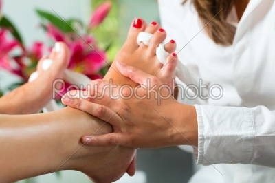 Woman in nail studio receiving pedicure