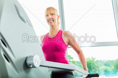 Woman in sport gym on stepper