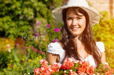 Woman in summer garden with flowers
